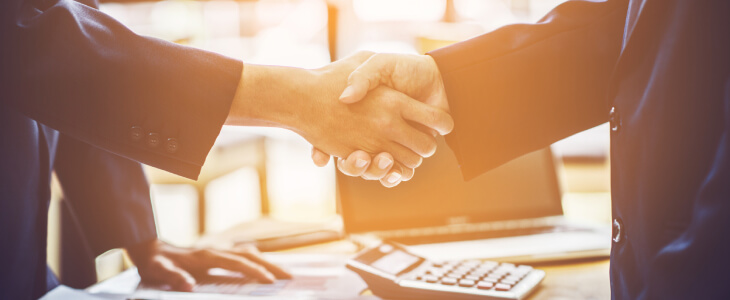 two business professional shaking hands mediation for business disputes